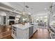 Bright open-concept kitchen featuring a large island, stainless steel appliances, and seamless flow into the living area at 2908 Stubble Field Dr, Raleigh, NC 27613