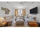 Comfortable living room with recessed lighting, large sectional, and large windows for natural light at 2908 Stubble Field Dr, Raleigh, NC 27613