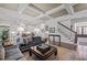 Open concept living room features coffered ceilings, hardwood floors, and flows into a bright kitchen at 2908 Stubble Field Dr, Raleigh, NC 27613