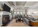 Open concept living room boasts fireplace, coffered ceilings, large windows, and views of the kitchen at 2908 Stubble Field Dr, Raleigh, NC 27613