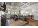 Open-concept living room boasts coffered ceilings, fireplace, large windows, and views of the kitchen at 2908 Stubble Field Dr, Raleigh, NC 27613