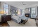 Cozy main bedroom with fireplace, ceiling fan, large windows, and sophisticated blue color palette at 2908 Stubble Field Dr, Raleigh, NC 27613