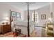 This main bedroom showcases a four-poster bed, hardwood floors, and natural light from the window at 2908 Stubble Field Dr, Raleigh, NC 27613