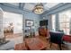 Spacious office features coffered ceiling, hardwood floors, TV, and view to the dining room at 2908 Stubble Field Dr, Raleigh, NC 27613