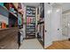Walk-in closet featuring custom wood shelving, cabinetry, and pull-out drawers at 2908 Stubble Field Dr, Raleigh, NC 27613