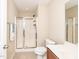 Bathroom featuring a glass-enclosed shower, light tile, and modern fixtures at 3000 Summerhouse Rd, Cary, NC 27519