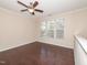 Spacious bedroom filled with natural light with a ceiling fan and hardwood floors at 3000 Summerhouse Rd, Cary, NC 27519