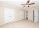 Bedroom features two closets, ceiling fan, carpet and three doorways at 3000 Summerhouse Rd, Cary, NC 27519
