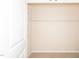 Walk-in closet features neutral carpeting and shelves at 3000 Summerhouse Rd, Cary, NC 27519