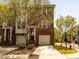 Brick townhome featuring an attached garage and well-maintained landscaping at 3000 Summerhouse Rd, Cary, NC 27519