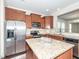 Well-equipped kitchen with stainless steel appliances and granite countertops provides ample counter space at 3000 Summerhouse Rd, Cary, NC 27519