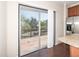 View from kitchen shows a large patio with railing with trees in the background at 3000 Summerhouse Rd, Cary, NC 27519