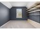 Well-lit room with built-in shelves and neutral carpet at 311 Windrush Ln, Durham, NC 27703