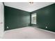 Welcoming bedroom with soft carpet, natural light, and a fresh coat of paint at 311 Windrush Ln, Durham, NC 27703