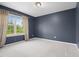 Peaceful bedroom with a large window offering backyard views at 311 Windrush Ln, Durham, NC 27703