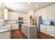 Modern kitchen with stainless steel appliances, granite countertops, and a stylish center island at 311 Windrush Ln, Durham, NC 27703