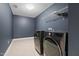Modern laundry room featuring stylish appliances and plenty of space for storage at 311 Windrush Ln, Durham, NC 27703