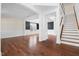 Spacious living room showcasing gleaming hardwood floors, decorative trim, and lots of natural light at 311 Windrush Ln, Durham, NC 27703