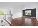 Open living room with hardwood floors, lots of natural light, and view of the entry at 311 Windrush Ln, Durham, NC 27703