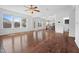 Bright and airy living room featuring hardwood floors and seamless access to the kitchen and outdoor spaces at 311 Windrush Ln, Durham, NC 27703