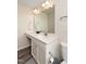 Bright bathroom featuring a large mirror, white cabinets, and quartz countertops at 313 Kineton Woods Way Way, Garner, NC 27529