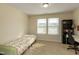 Bright bedroom with a large window and a functional desk area at 313 Kineton Woods Way Way, Garner, NC 27529
