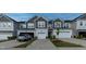 A view of multiple townhomes with attached garages and well-maintained lawns at 313 Kineton Woods Way Way, Garner, NC 27529