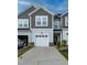 Charming two-story townhome with attached garage and neutral siding at 313 Kineton Woods Way Way, Garner, NC 27529