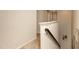 Hallway with carpet floors and wooden railing on a staircase leading to upper or lower level at 313 Kineton Woods Way Way, Garner, NC 27529