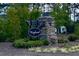 Welcome to Minglewood, a charming community entrance with lush greenery and stone accents at 313 Kineton Woods Way Way, Garner, NC 27529