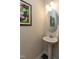 Elegant powder room with pedestal sink and decorative mirror at 313 Kineton Woods Way Way, Garner, NC 27529