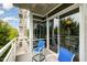 Relaxing balcony with blue chairs, a glass table, and sliding glass doors at 3210 Environ Way, Chapel Hill, NC 27517