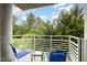 Inviting balcony with blue chairs overlooking lush greenery and blue skies at 3210 Environ Way, Chapel Hill, NC 27517