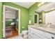 Well-lit bathroom with granite countertop, white cabinets, and modern fixtures at 3210 Environ Way, Chapel Hill, NC 27517