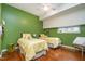 Cozy bedroom with hardwood floors, dual beds, and bright yellow accents at 3210 Environ Way, Chapel Hill, NC 27517