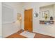 Inviting entryway with a wooden door, coat closet, stylish decor, and hardwood flooring at 3210 Environ Way, Chapel Hill, NC 27517