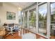 Bright home office with a workspace, balcony access, and hardwood floors overlooking a treelined view at 3210 Environ Way, Chapel Hill, NC 27517