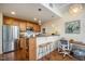 Stylish kitchen featuring stainless steel appliances, a breakfast bar, wine storage, and modern lighting at 3210 Environ Way, Chapel Hill, NC 27517