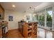 Open-concept kitchen with a breakfast bar, stainless appliances, wine rack, and access to the balcony at 3210 Environ Way, Chapel Hill, NC 27517