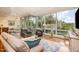 Bright living room with hardwood floors, large windows showcasing tree views, and a comfortable seating arrangement at 3210 Environ Way, Chapel Hill, NC 27517