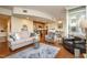 Cozy living room showcasing hardwood floors, comfortable seating, and an open layout connected to the kitchen at 3210 Environ Way, Chapel Hill, NC 27517