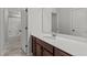 Bathroom with white cabinets, quartz countertop and a tub with shower at 323 Oak Branch Trl, Garner, NC 27529