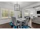 Bright dining room featuring a modern chandelier and large windows at 323 Oak Branch Trl, Garner, NC 27529