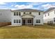 A home's exterior showcases a well-maintained yard, screened porch, and private backyard at 323 Oak Branch Trl, Garner, NC 27529