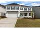 Charming two-story home with a well-manicured lawn and a two-car garage at 323 Oak Branch Trl, Garner, NC 27529