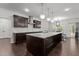Modern kitchen with granite countertops, a large island, and stainless steel appliances at 323 Oak Branch Trl, Garner, NC 27529