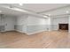 Basement featuring wood-look floors, a fireplace, and an exterior door at 3402 Pat Tilley Rd, Bahama, NC 27503