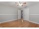 Bedroom featuring hardwood floors, a ceiling fan with light, and closet doors at 3402 Pat Tilley Rd, Bahama, NC 27503