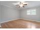 A bedroom with hardwood floors, a ceiling fan with light, and a window at 3402 Pat Tilley Rd, Bahama, NC 27503