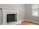 Close up of a white fireplace with a decorative screen and tools at 3402 Pat Tilley Rd, Bahama, NC 27503